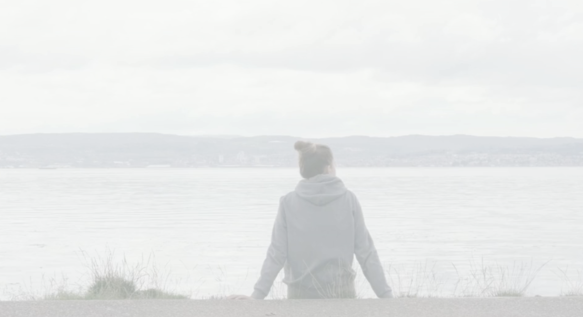girl on the coast staring off into ocean